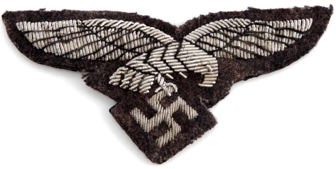 WWII GERMAN THIRD REICH LUFTWAFFE OFFICER PATCH: Breast eagle patch of a Luftwaffe officer. Silver bullion wire construction. In very good condition. Does not fluoresce under blacklight. Measures 3 1/2 inches wide. This lot has a reserve.