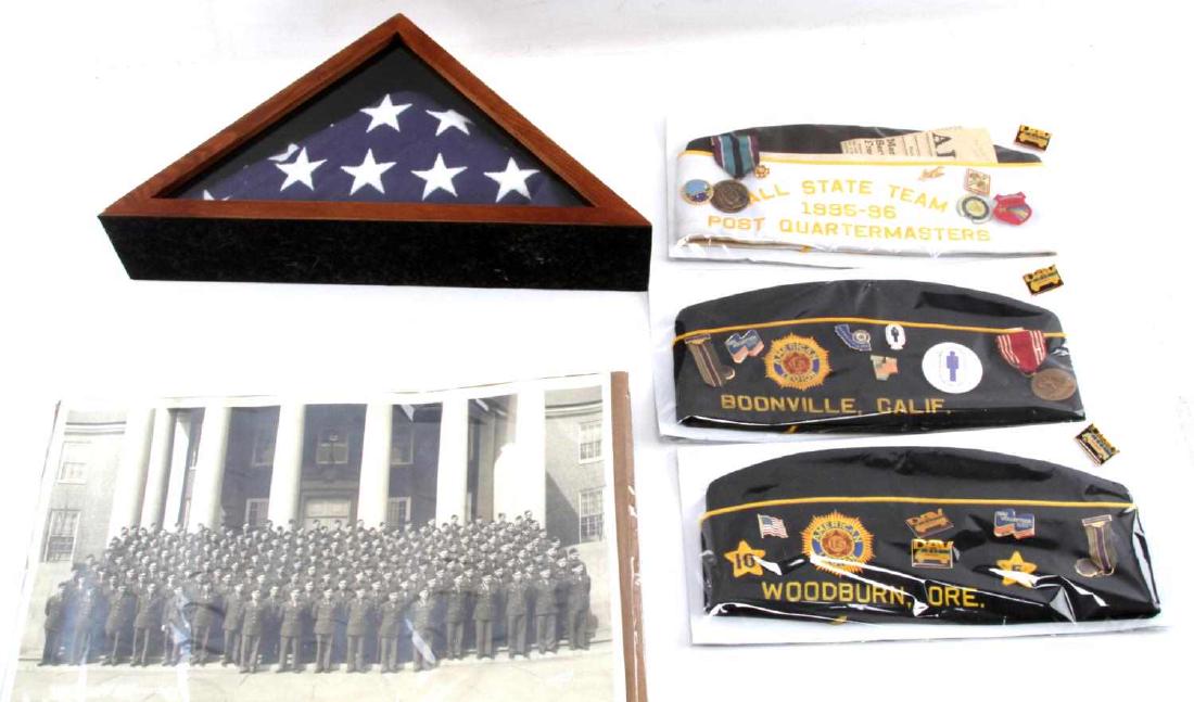 WWII AMERICAN LEGION LOT PATCHES HATS FLAG: This lot includes 3 US American Legion hats with many assorted pins, a framed US military flag, and a WWII division photograph. All items are in very good condition.