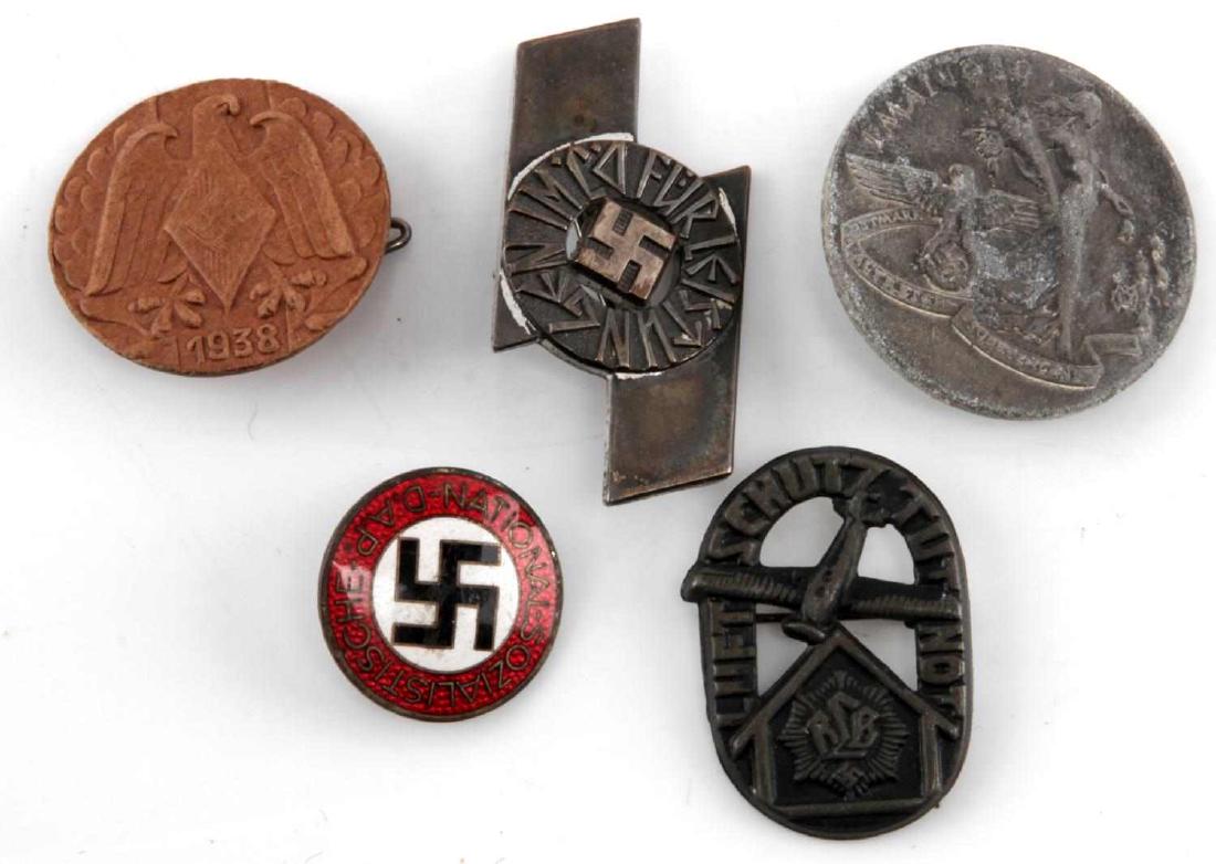 MIXED LOT OF 6 GERMAN WWII THIRD REICH TINNIES: Lot includes NSDAP party pin (RZM M1/15), wood 1938 party pin, RLB Luftschutz, 1 May 1939 (C. Schlenker), and one uknown SS (RZM M1/120).