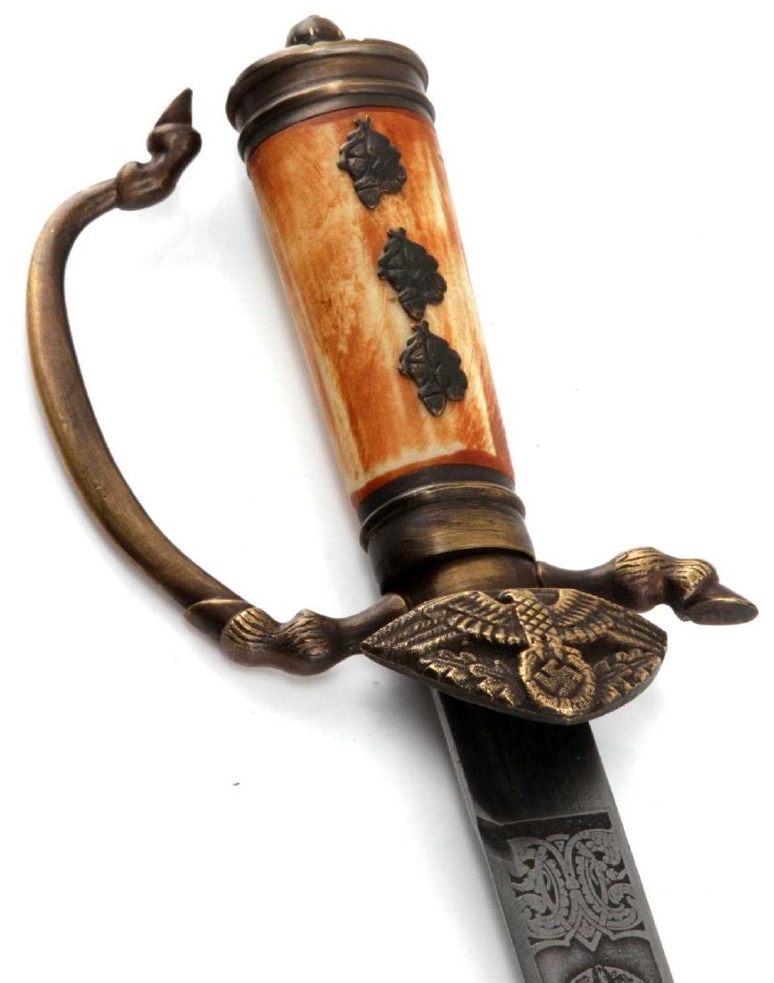 GERMAN WWII GOERING PRESENTATION DAGGER 1937 COPY: A copy of the Goering 1937 presentation dagger. Blade features the signature of Goering acid washed in as well as the date '1937'. Faux bone handle. With black leather bodied scabbard. Measures 20 1/2