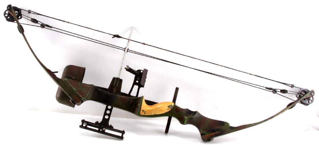 CAMO PAINTED FULL SIZE COMPOUND BOW W QUIVER: Hand painted mixed camp pattern. 44 1/2" in length. Plastic, wood, and fiberglass construction. G condition.