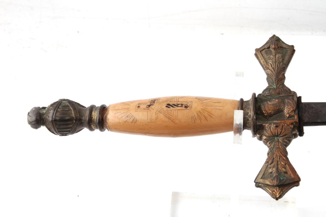 ANTIQUE MASONIC FRATERNAL ORDER DRESS SWORD: Dress sword of a member of a fraternal order. Blade has a masonic square and compasses emblem on it. The grip is made of highly polished wood with some wear. The hilt, sheath, and blade all have a kni