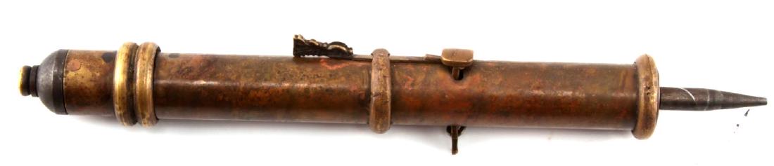 ANTIQUE JAPANESE MIXED METAL DART GUN: This late 1800s - early 1900s dart gun is shaped like an Imperial cannon and measures 7 and 1/4" in length. It fires a metal dart projectile using a spring mechanism and is quite powerful and lethal. 