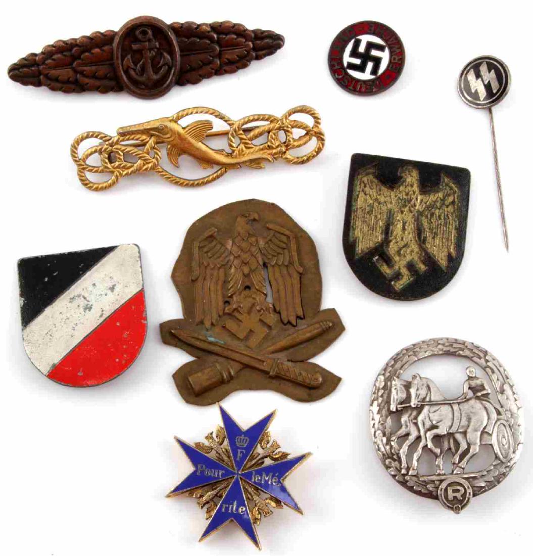 LOT OF 9 GERMAN THIRD REICH WWII BADGES & PITHS: Lot contains Panzer shield pith, General assault badge, Afrika corps shield pith, SS pin, and more. All badges are in good condition and do not show signs of damage outside of normal aging. Assault ba
