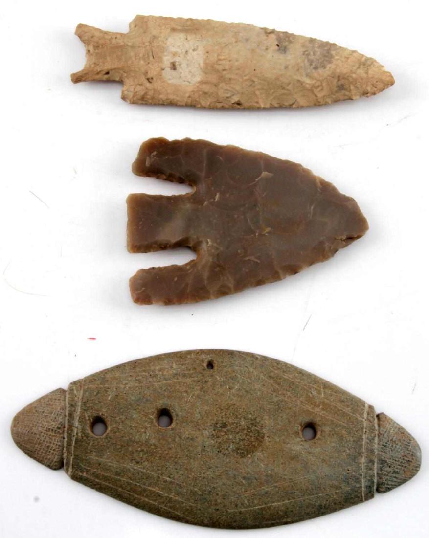 LOT OF ARTIFACTS GORGET AND 2 ARROWHEADS STONE: Gorget is football shaped with carved design at each end and four holes (5.5 inch). One cream lanceolate point with parallel flaking and bifurcated base (4.5 inch). The Lost Lake type is gray with bro