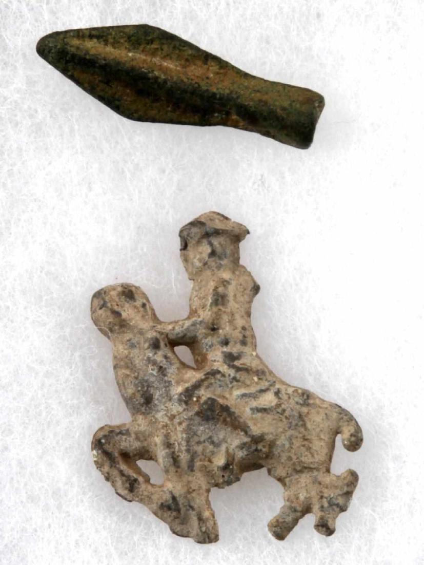 MEDIEVAL BRONZE GUY ON HORSEBACK & SPEAR HEAD: Spear head has green patina, measures 1.5 inches and weighs 5.3 grams. The guy on horse measures 1.75 inches long and weighs 25 grams. Good condition.