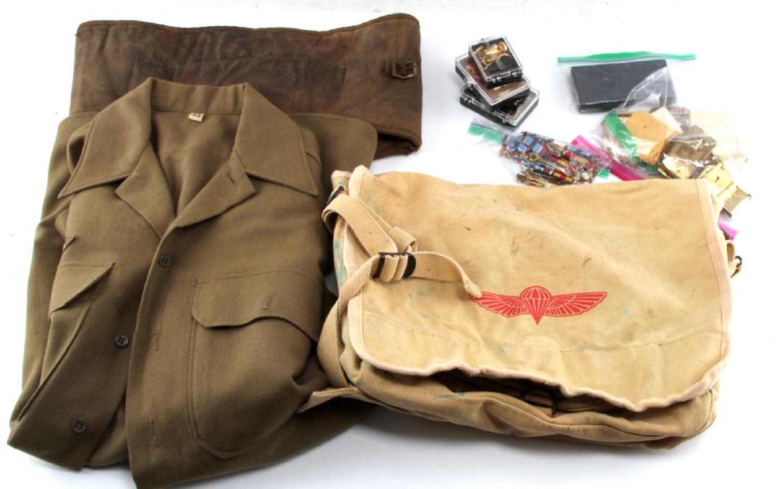 MULTI CONFLICT WWII VIETNAM AMERICAN MILITARIA LOT: This lot includes ribbon bars, uniform buttons, US military jacket with "ruptured duck" badge, WWII Victory and Marine Corps Reserve medals, bag of brass military belt buckles, US Army Paratrooper bag