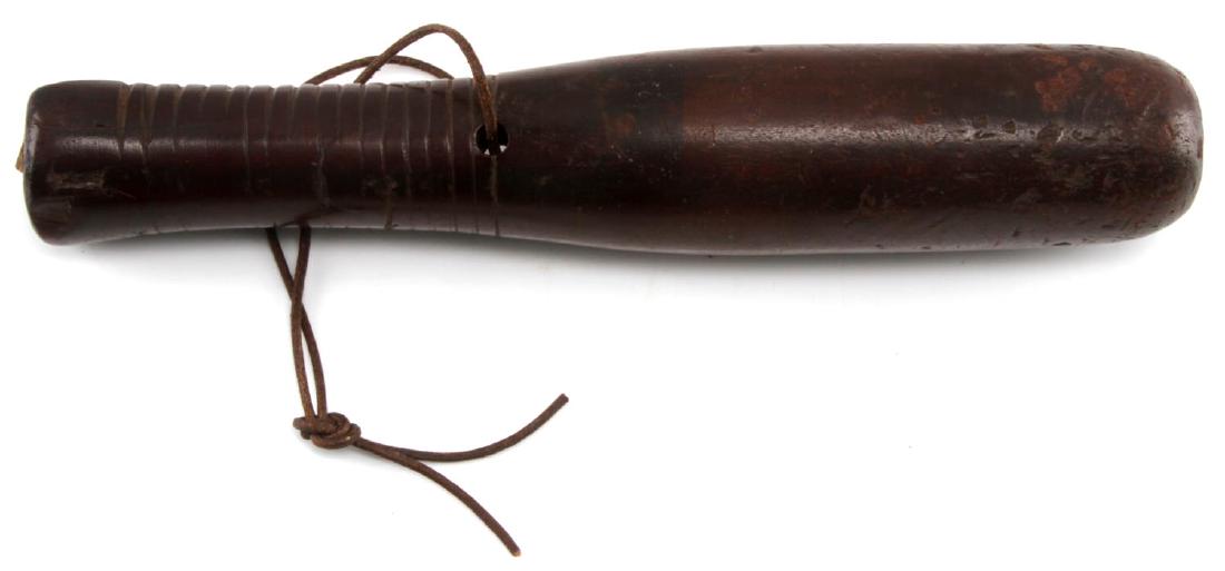 CIRCA 1860 BRITISH POLICE WOOD BATON TRUNCHEON: Large chip in handle. Mahogany construction. With leather hand sling. Tip shows strong impact indentations. Measures 10" in length. VG condition. G3