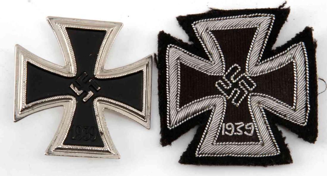 WWII THIRD REICH FIRST CLASS IRON CROSS LOT OF 2: First class metal Iron Cross pin. Thin vertical metal pin on back. No makers mark. Second cross is a silver bullion wire embroidered Iron Cross on black wool. Fluoresces under black light. Unauthentic
