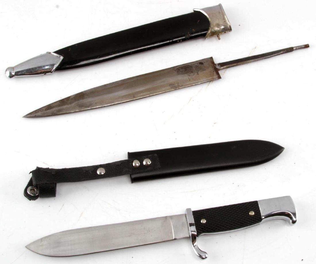 WWII GERMAN THIRD REICH SS DAGGER & YOUTH DAGGER: WWII German Third Reich Waffen SS dagger lot. Includes a Nazi Youth dagger replica. Overall length 10.5 inches, blade length 6 inches and stainless. Handle is black checkered nylon with a full color s
