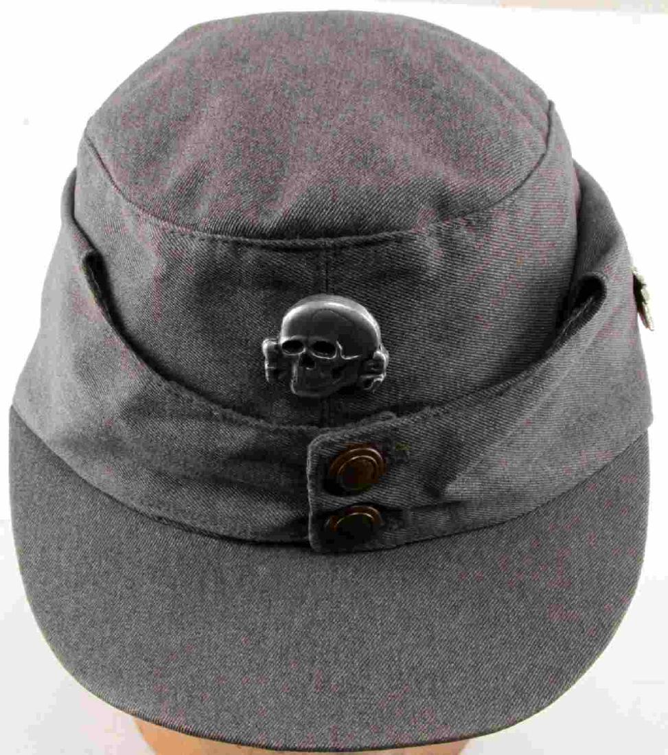 WWII GERMAN THIRD REICH SS MOUNTAIN TROOP M43 CAP: M43 cap of a Waffen SS mountain division. Has metal Totenkopf badge on the front and an edelweiss badge on the left side of the cap. Brass buttons and leather lining inside. In very good condition ove