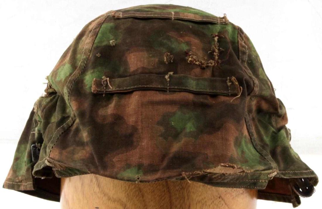 WWII GERMAN WAFFEN SS REVERSIBLE HELMET COVER: Waffen SS cloth helmet camouflage cover. Green/salmon/brown splotch pattern reversible to Autumn orange/brown. Correct small springs and rocker arms. Cover is in good condition but does show signs of 