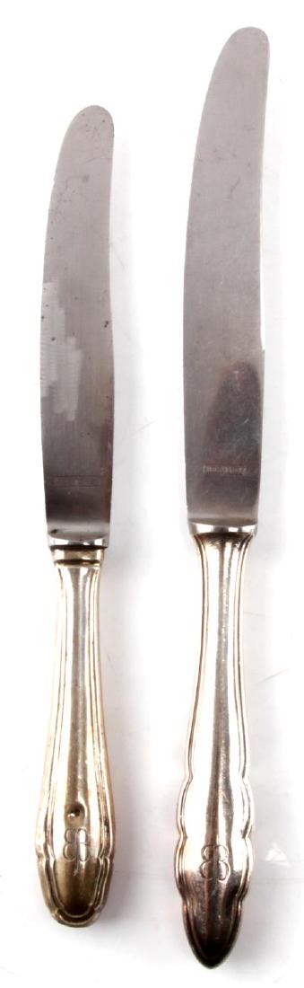 WWII EVA BRAUN THIRD REICH HALLMARK 800 FLATWARE: WWII era Eva Braun Third Reich silverware set. Two knives. Larger measures 9.75 inches and smaller measures 8.25. Marked with the Eva Braun butterfly. Hallmark 800 silver. Rostefrei maker's mark. SV2.