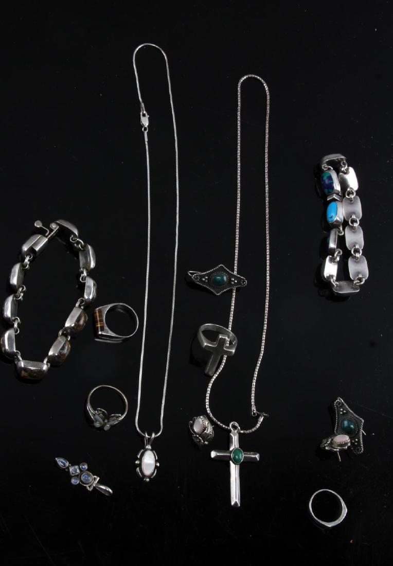 OLD PAWN SOUTHWESTERN VINTAGE SILVER JEWELRY LOT: Total weight 108 grams. Rings size from 5.5 to 8.25Bracelets measure 7 inches in length and necklaces 18 inches. Cross pendant signed Ernest Pino. Stones featured Turquoise, malachite, tigers eye and