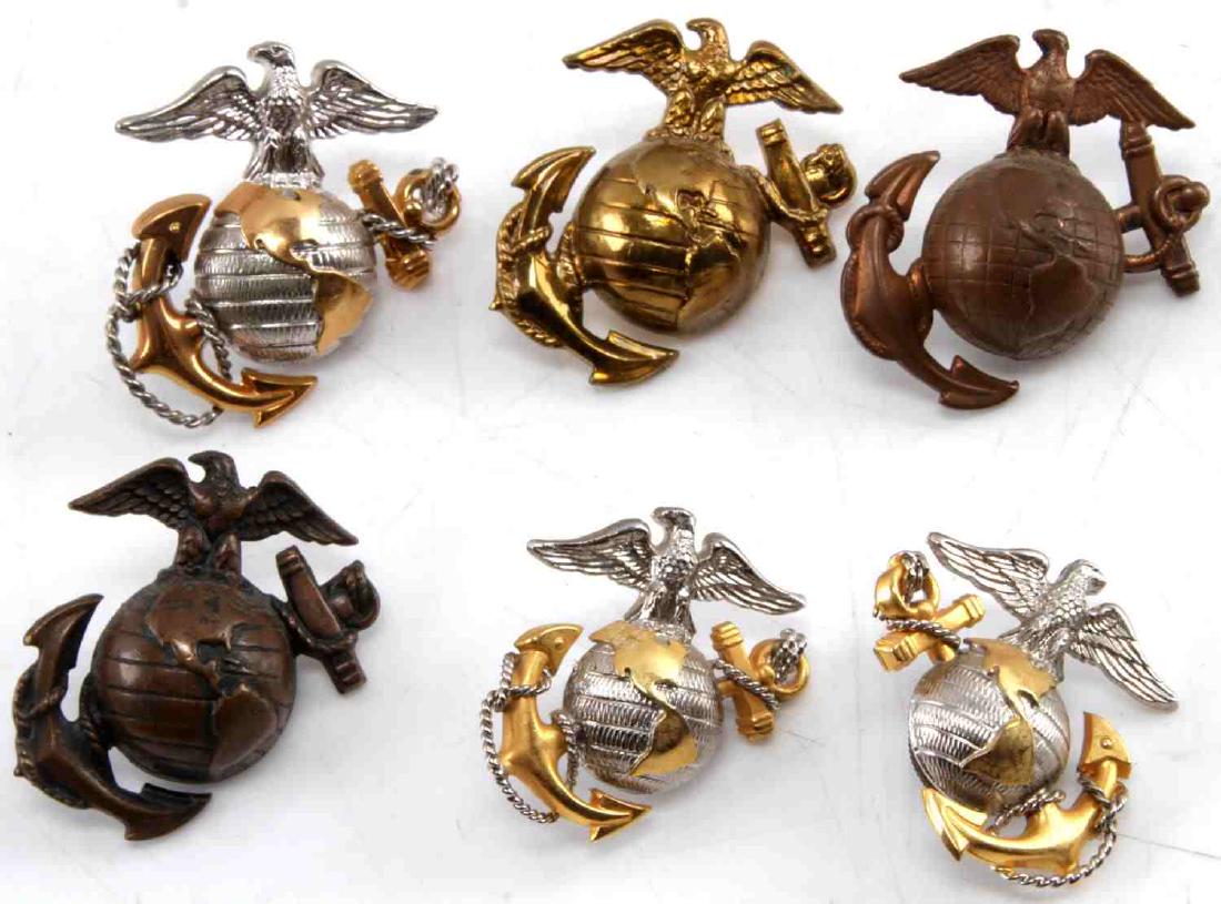 WWII US MARINE CORPS EAGLE GLOBE ANCHOR BADGE LOT: This lot includes a variety of USMC EGA badges including: 3 Sterling silver USMC Officer barracks hat badges, 1 pre-1936 longitude line badge, and 2 brass USMC hat badges. All badges are screw-back an
