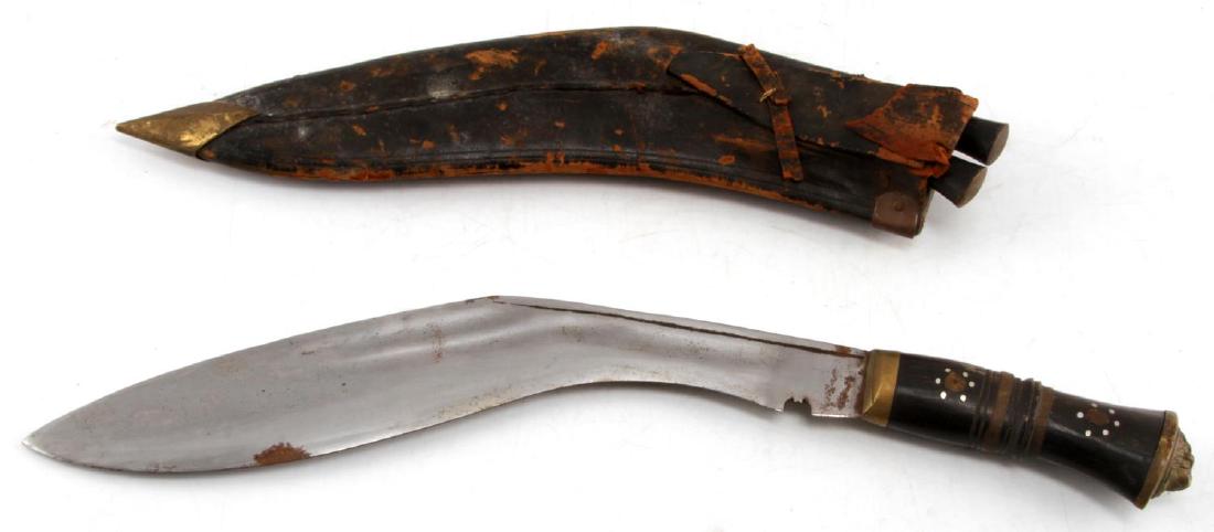 VINTAGE NEPALESE GHURKA KUKRI KNIFE IN SHEATH: Nepalese kukri knife with leather sheath and small karda and chakmak knives. In very good overall condition, the leather of the scabbard shows some wear from age. Measures 18 inches in length overall.