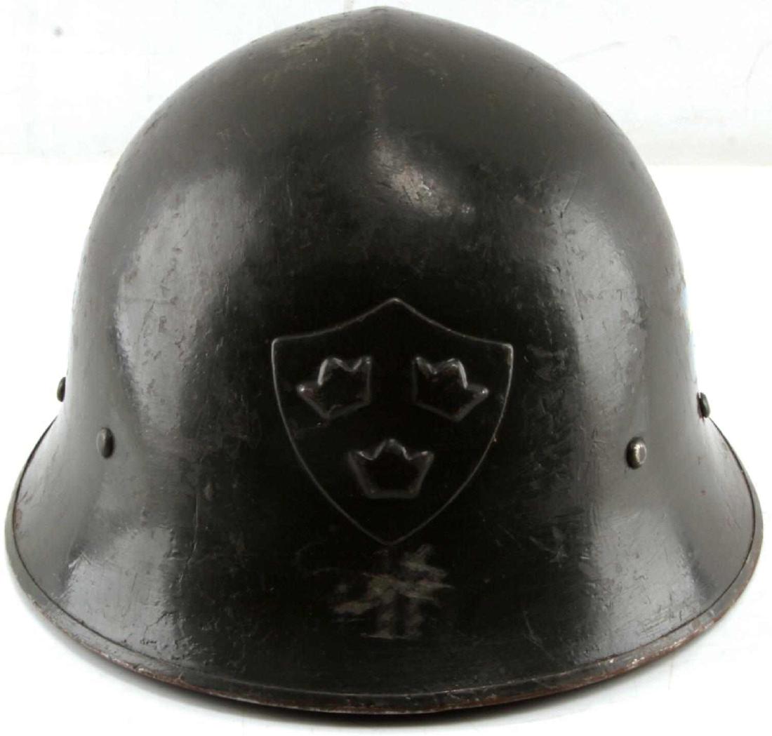 WWII IRISH STEEL HELMET & LINER 1937 IRELAND: Green steel helmet with Irish Coat of Arms shield to front center, blue shield with 3 crowns decal to each side. Three finger leather liner stamped 1937, 63 and has name written on it. Minor wear. Ove