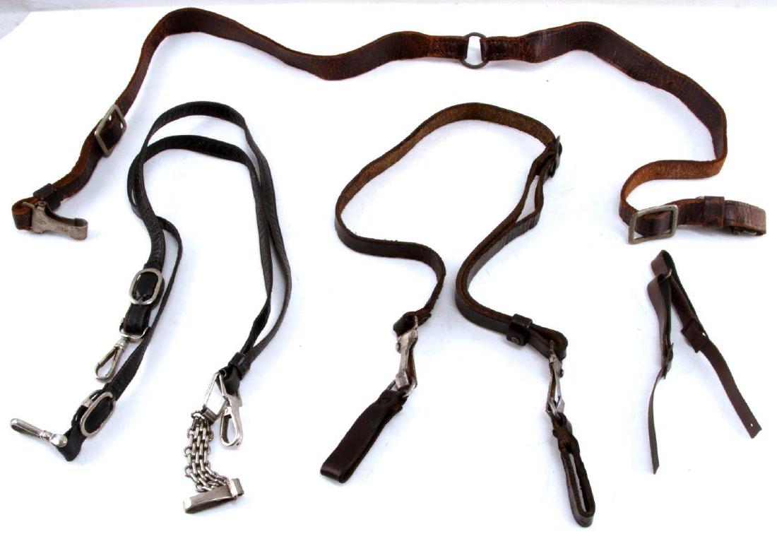 13WWII GERMAN CROSS STRAP SWORD HANGER LOT OF 4: This lot includes 2 German Sam Browne SA/political belt straps, 1 Sword Hanger, and 1 SA chin strap. The Sam Browne straps are both made of brown leather and are both RZM stamped on their clips. Both 