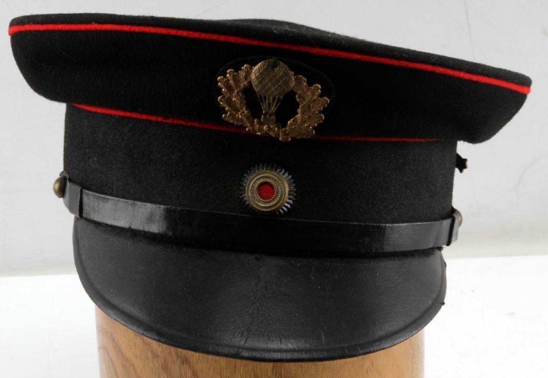GERMAN HINDENBURG ZEPPELIN SERVICE PILOT CAP: Zeppelin service pilot cap with a hot air balloon badge on the front and a Hindenburg badge on the left side of the cap. Inside of the hat is size marked '54 1/2'. The wreath of the hot air balloon is