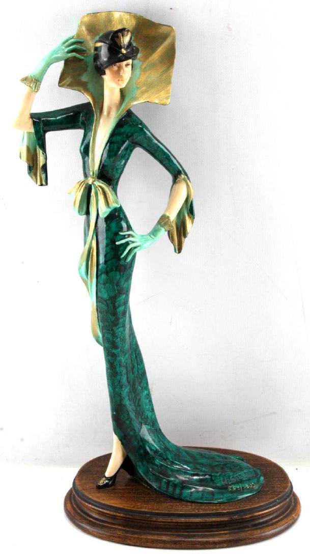 A SANTINI COMPOSITE ART NOUVEAU WOMAN STATUETTE: A. Santini large porcelain art nouveau sculpture. Woman in green dress and hat posing. Green felt on bottom. Signed at bottom of dress A. Santini and numbered 553/3500. Measures 18.5 inches by approxi