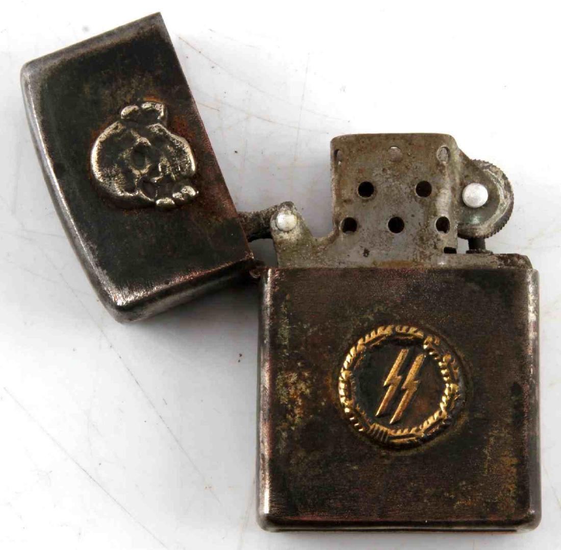 WWII GERMAN 3RD REICH WAFFEN SS CIGARETTE LIGHTER: Waffen SS marked cigarette lighter. Has a Totenkopf on the lid, sig runes on the body, and RZM mark on the base. In very good condition overall, still sparks. Unauthenticated/Sold 'as is' This lot has