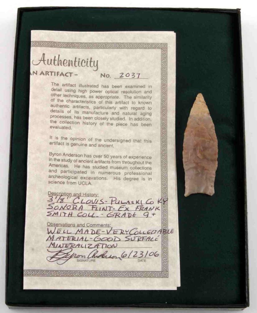 PALEO LITHIC CLOVIS POINT ARROWHEAD W COA: This Clovis point is composed of Sonora flint, is medium-small size, auriculate, and unfluted, with concave ground base with ears. It comes with certificate of authenticity, is graded 9+, and has prec