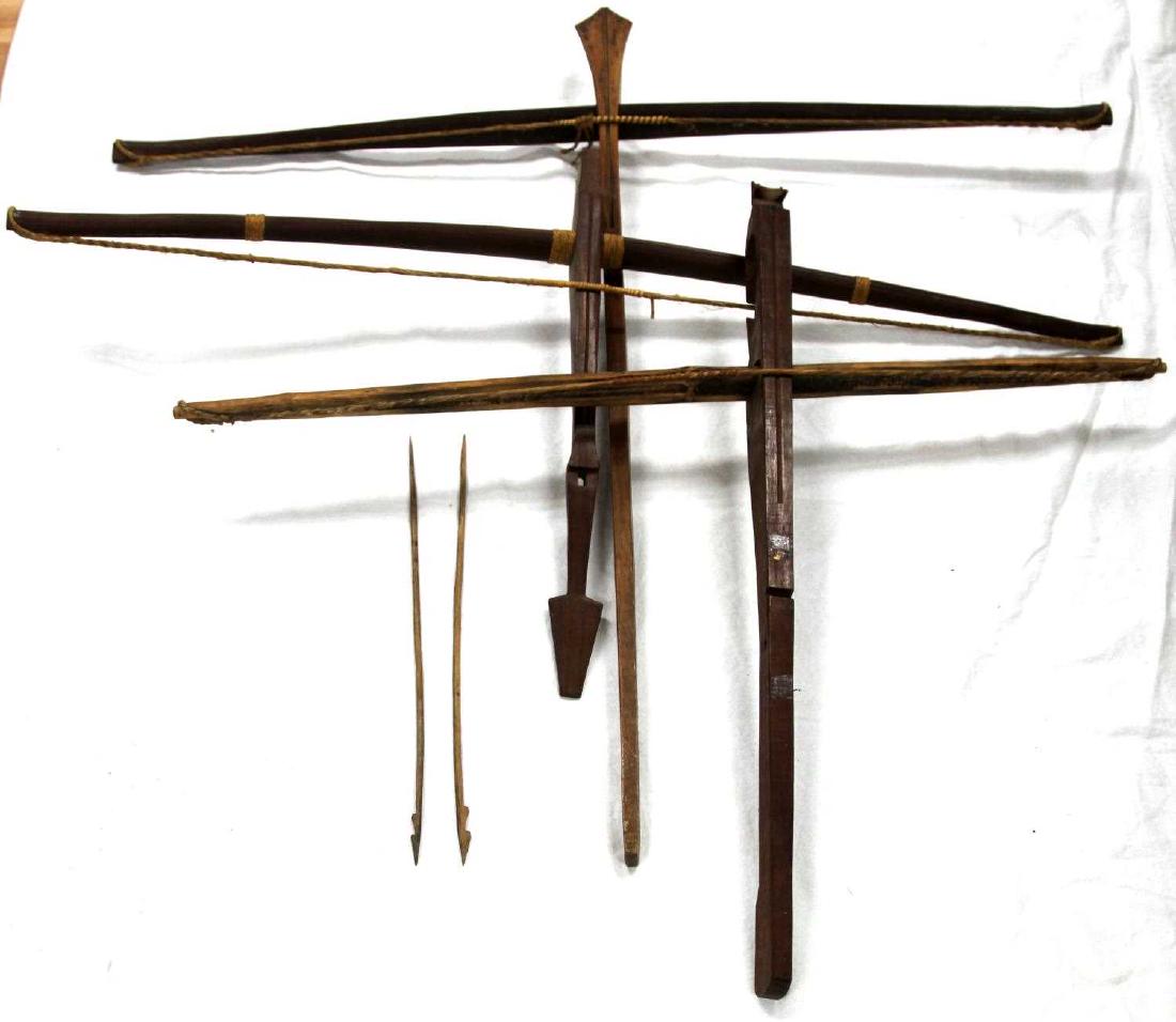 3 VIETNAM ERA MANTAGNARD CROSSBOW LOT W 2 ARROWS: Three Mantagnard bows and two arrows. One measuring 37 inches by 34 inches with diamond shaped head. One measuring 32.5 inches by 265.5 inches with zoomorphic head. One measuring 38 inches by 19.5 inc