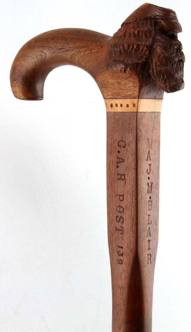 US G A R UNION VET ARCHIVE WITH WOODEN CANE & DOCS: Cane measures 32 inches long. The head of the solder is carved into the handle of the cane. Has original ferrule tip with a deer head. Named Maj. M. Blair. 143 PENN. VOLS. G.A.R. post 139. Has framed 