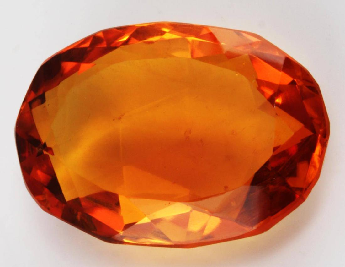 108.80 TCW OVAL CITRINE QUARTZ EARTH MINED: Good luster and clarity. Hue enhanced. Two dings to concave or rear face. Measures 40 X 28 X 13mm. Comes with certified card from Earth Mined Gemstone Testing Laboratory.