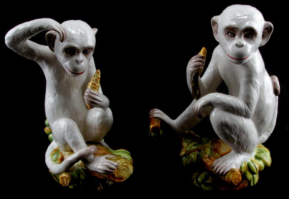 ITALIAN CAPODIMONTE MONKEY PORCELAIN FIGURINE LOT: Matched pair of Capodimonte porcelain monkey statues. Each has 'Made in Italy' sticker. Both are in very good condition. Measure 10 and 10.5 inches in height.