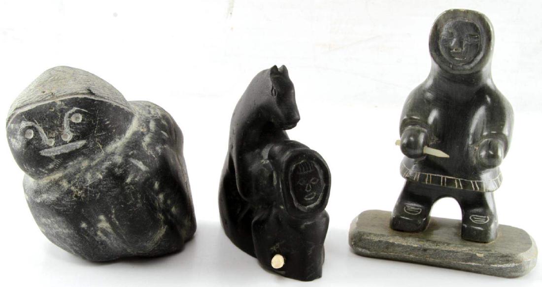 3 INUIT CARVED SOAPSTONE SCULPTURES SIGNED CANADA: One bear with child, one Eskimo (signed Dimu), one other carved figure. All are signed or with Canada sticker to bottom. Tallest measures 5.25 inches. About 4 inches wide. Little wear to Eskimo head, 