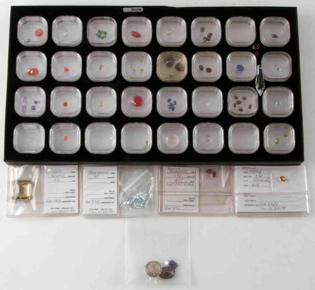 LOT OF ASSORTED GEMSTONES DIFFERENTS SIZES CUTS: Few have a descriptive card. Lot includes: topaz, smoky quartz, citrine, aquamarine, rubilite tourmaline, lapis, peridot, garnet, amethyst, carnelian and more. Most stones are in plastic boxes. Measur