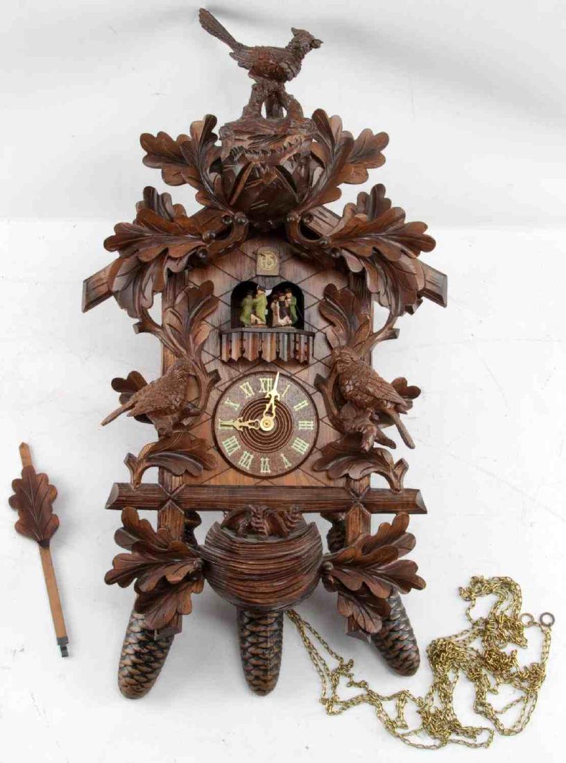 REUGE LARGE WOODEN SWISS CUCKOO CLOCK: Large wooden Reuge classic cuckoo clock. Sticker on bottom says "Reuge Frohliche Wanderer Edelweiss Swiss Musical Movement" Measures 21 inches with topper, 17 inches without topper. Pendant measures 9