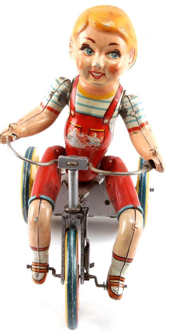 ART KIDDIE CYCLIST MECHANICAL LITHO WIND UP TOY: This is a 1930s "Kiddie Cyclist" windup toy in good working condition. Measures about 7.5" l x 4.25" x 8.5" h. mechanically sound; winds and rings bell. Missing one handlebar grip and 1 hand has come 