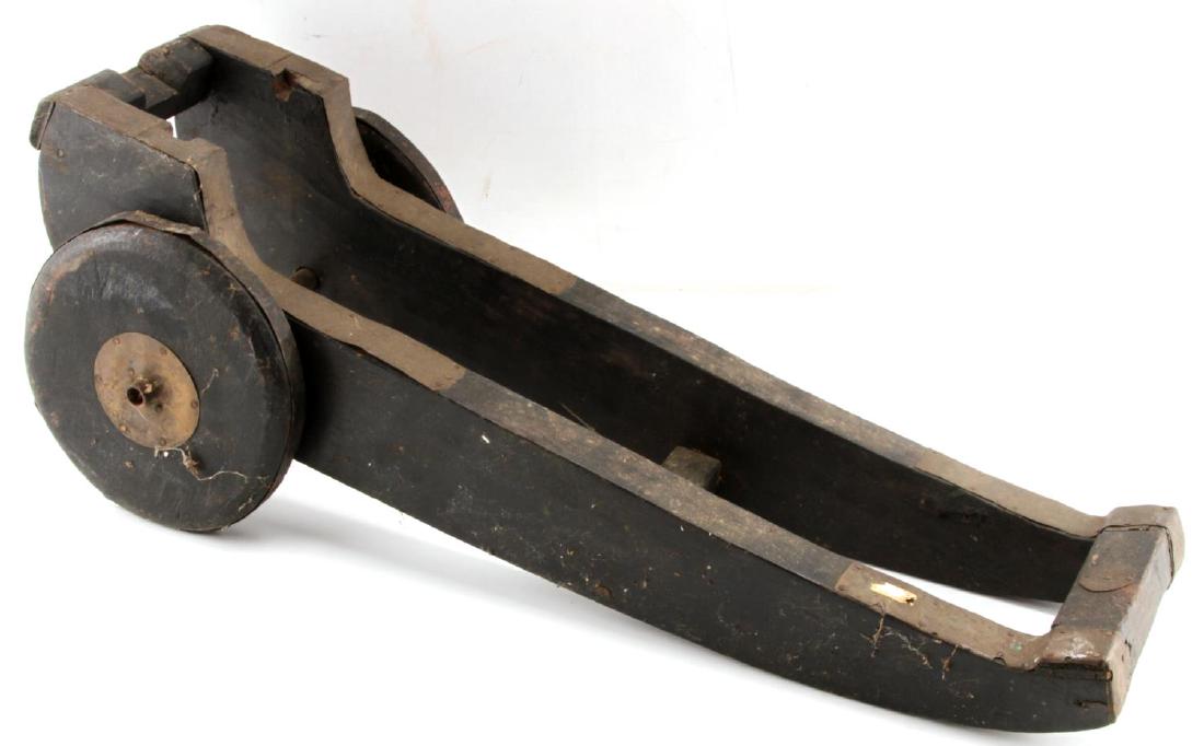 ANTIQUE DECK CANNON CARRIAGE WOOD & BRASS 24X6X9": Designed for small deck of signal cannon the, trunion wheel the cannon sits the slots measures 4.5 inches, the connon slot is 1 3/4 inches. Wheels are hand carved and has flat steel tire, quite unusua