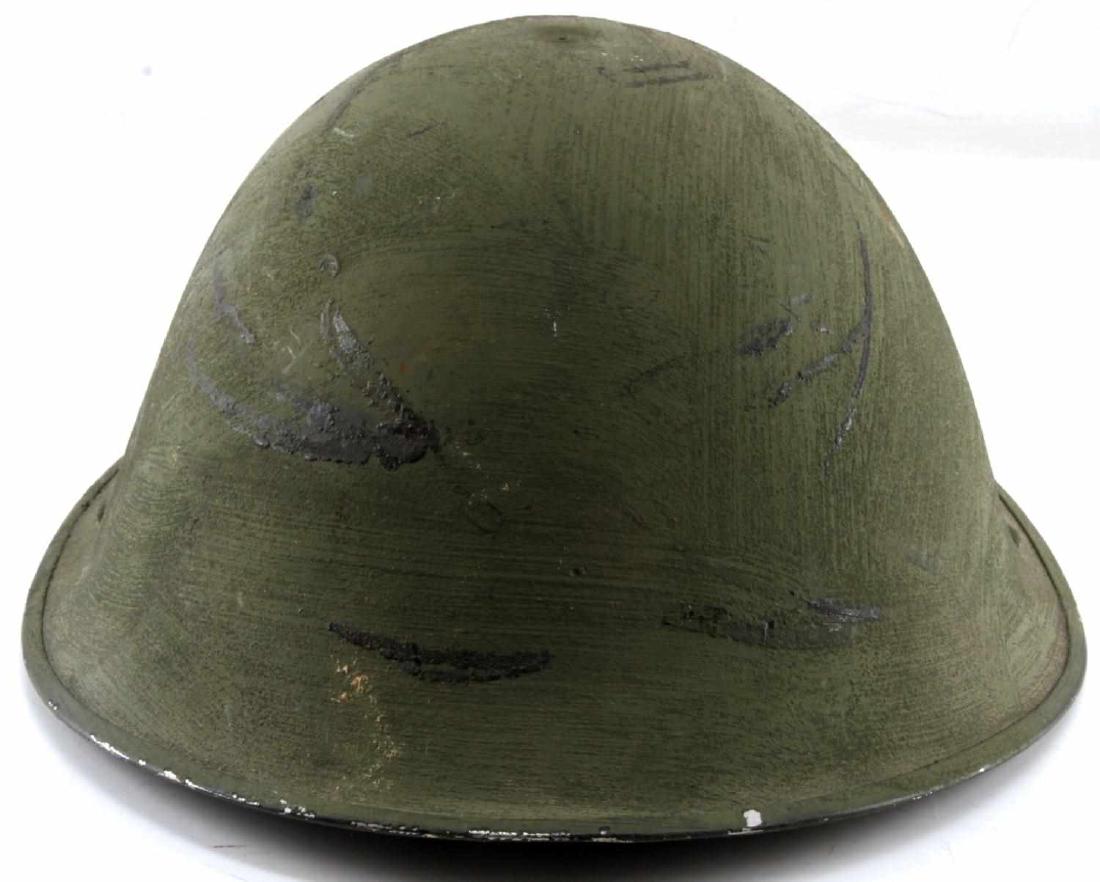 WWII BRITISH COMMONWEALTH TURTLE BRODIE HELMET: This is a nice WWII British P1944 D-Day camo Turtle/Brodie helmet with intact leather lining and chinstrap. It is in very good condition overall with some staining present on the strap and shell. It i