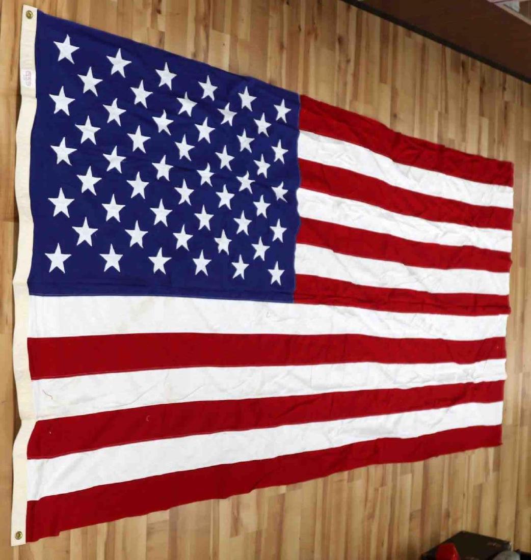 LARGE SEWN 50 STAR AMERICAN US FLAG: This is a large 9' X 4.75' American flag. It is 100% cotton and the stars are sewn on. Flag and hoist are in very good condition. Minor stains and snags are present.