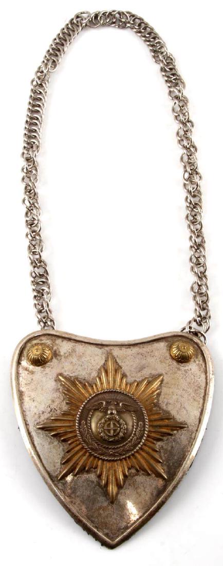 WWII GERMAN THIRD REICH SA STANDARD BEARER GORGET: Brass relief eagle/sun wheel swastika on the center panel affixed to a gilt sunburst and mounted on a convex nickel shield. Domed gilt bosses with designs in corners. Reverse covered in blue cloth wit