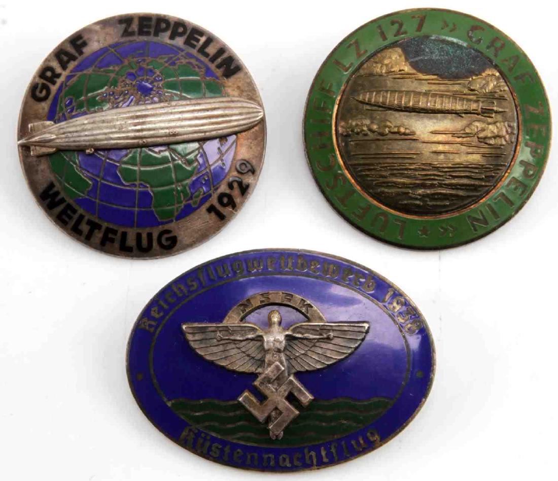 GERMAN THIRD REICH ZEPPELIN NSFK BADGE LOT OF 3: Three badges, two pre-Third Reich LZ 127 Graf Zeppelin badges and one NSFK 1938 flying competition badge. All have a maker mark on the back and are in very good condition.