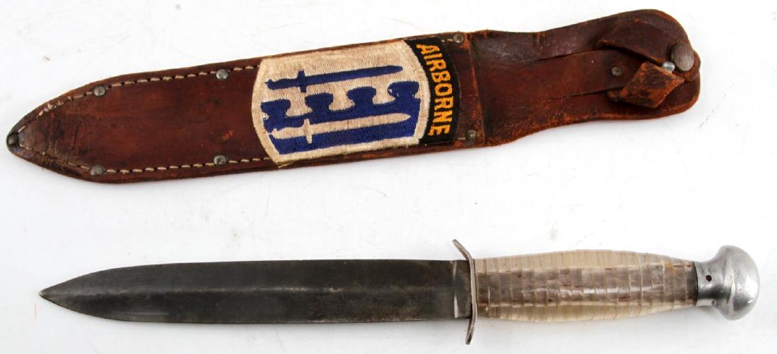 WWII US ARMY 2ND AIRBORNE INFANTRY BRIGADE KNIFE: Fighting knife with leather scabbard and clear plastic grip. On the leather scabbard is a patch for the US Army's 2nd Airborne Infantry Brigade. In very good condition overall. Knife measures 11 1/4 i