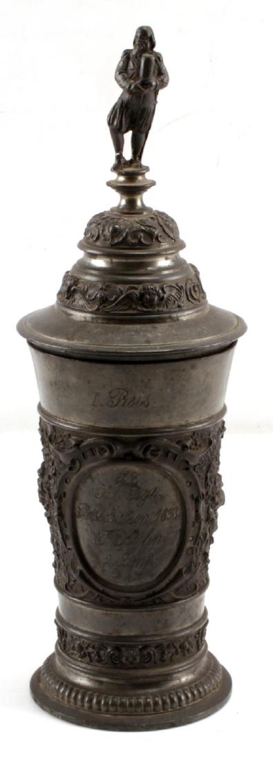 1898 IMPERIAL GERMAN MILITARY PRESENTATION CUP: 1898 Imperial German pewter presentation cup. Inscribed on front with 23rd Infantry Regiment from 1898. With lid on measures approximately 11 inches. Portrait on back and figural decoration in relief 