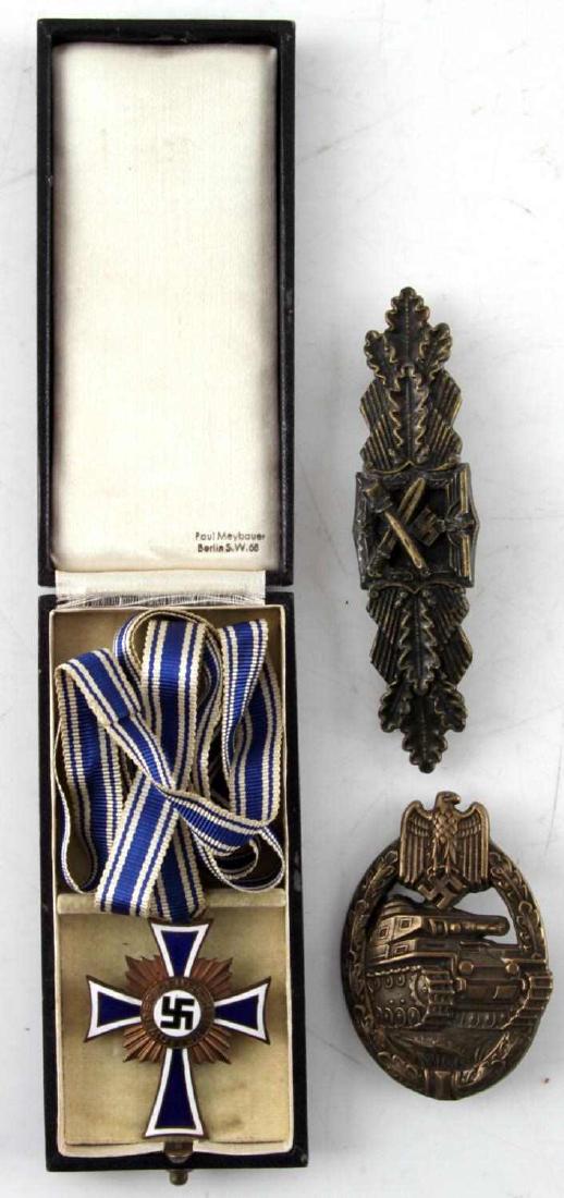 GERMAN CLOSE COMBAT PANZER ASSAULT & CROSS LOT: This lot includes 1 Bronze Close Combat badge reverse stamped "FEC. W. E. Peekaus Berlin," 1 Bronze Panzer Assault badge, and 1 cased Cross of Honor of the German Mother. Cross is engraved 16. Decembe