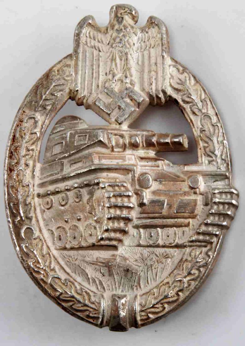 WWII GERMAN 3RD REICH SILVER PANZER ASSAULT BADGE: German Panzer Assault Badge in silver. Has 'DH' mark on the back. In very good condition. Single piece construction, possibly tin.