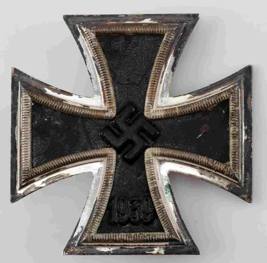 WWII THIRD REICH GERMAN IRON CROSS FIRST CLASS: WWII Third Reich German Iron Cross, first class. Swastika with 1939 on front. Stout pin on back with 90 degree lie. In good condition with slight discoloration. G3.