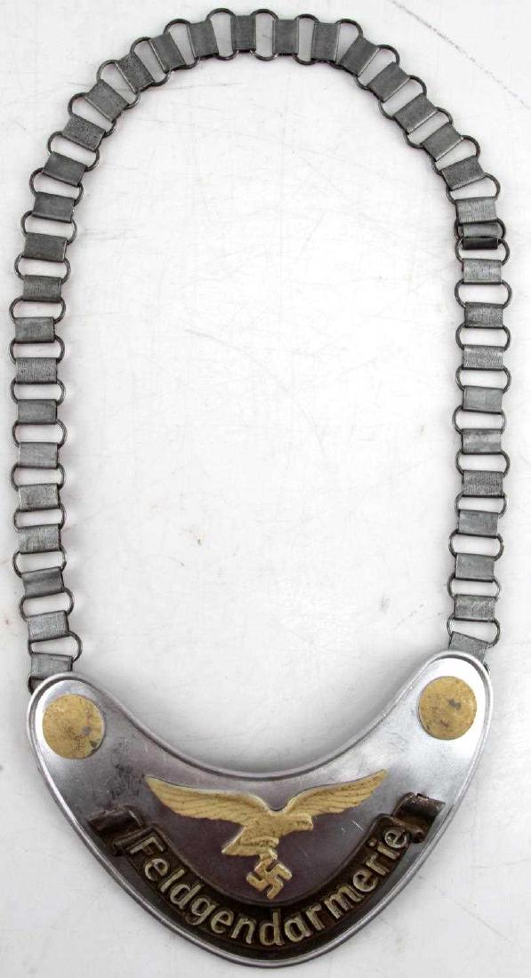 WWII GERMAN THIRD REICH LUFTWAFFE POLICE GORGET: Luftwaffe Feldgendarmerie gorget. Has Luftwaffe Reichsadler 1935 mark on back hook. In very good condition. Minor wear to the phosphorescent paint.