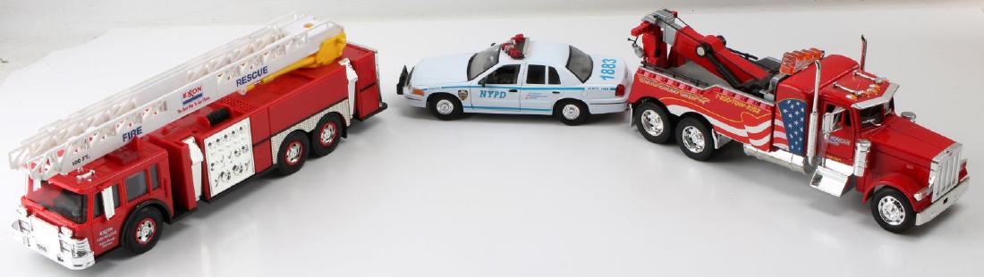 PETERBILT WELLY EXXON DIE CAST CAR & TRUCK TOY LOT: This lot includes 1 Peterbilt 1:32 JADA tow truck, 1 Welly 1:24 1999 Crown Victoria NYPD police car, and 1 Exxon fire rescue fire truck. Very good original conditions.