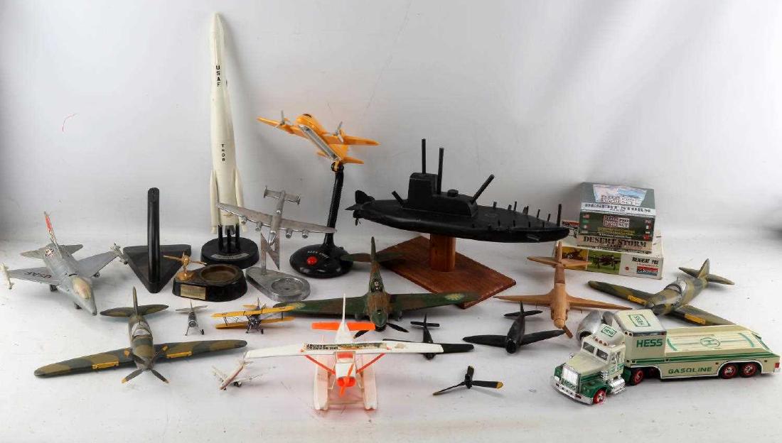 MIXED LOT OF MODELS SUBMARINE PLANES THOR ROCKET: Mixed military toy model lot including: USAF Thor rocket (piece broken off), black wooden submarine model (16 inch), camo wooden planes, plastic planes, resin models, one pewter model, Hess semi truck