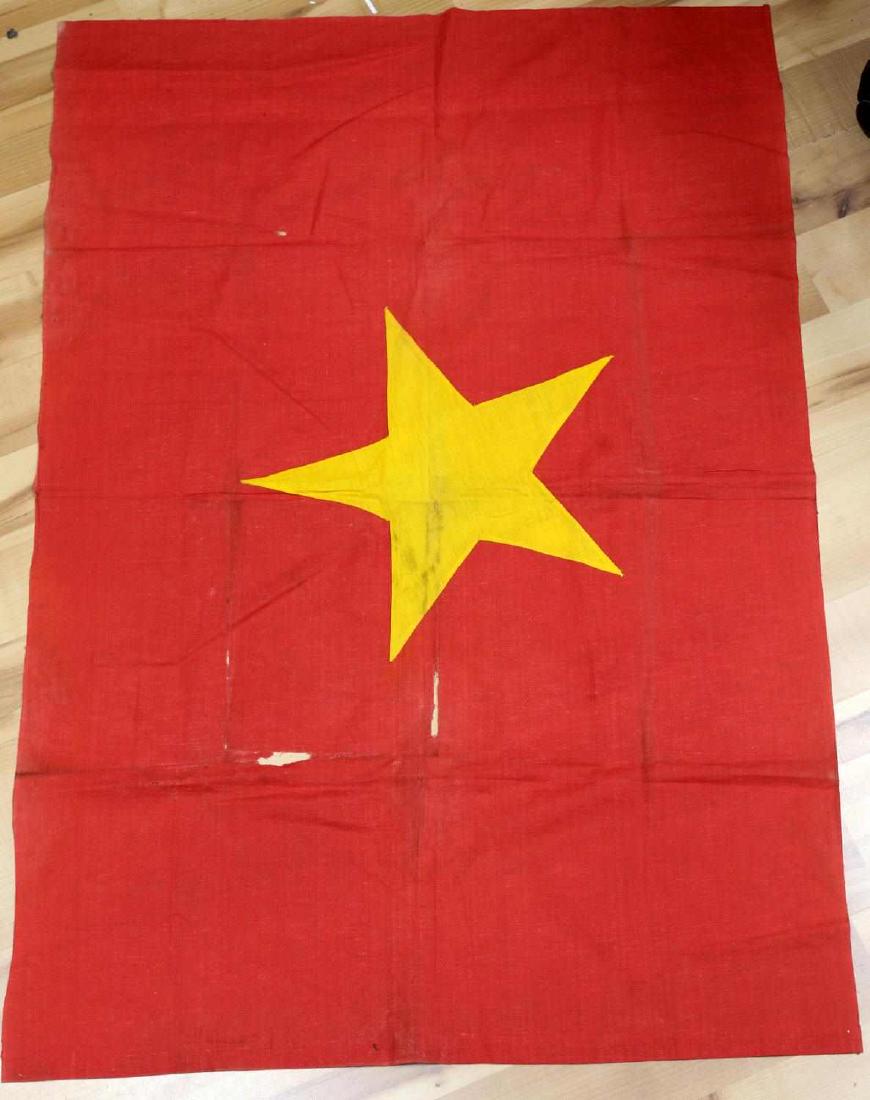 VIETNAM WAR VIETNAMESE COMMUNIST BANNER FLAG: This is a Vietnam War era Vietnamese flag. It measures 44.5" X 30" and is in fair condition. Some holes are present along with general fabric wear and fading.