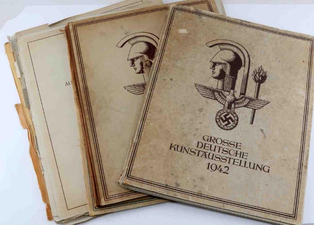 WWII GERMAN GROSSE DEUTSCHE KUNSTAUESSTELLUNG LOT: This lot includes 3 Grosse Deutshche Kunstausstellung catalogues containing images of works that are exemplary of Third Reich artistic ideals. Catalogues vary in condition. Binding wear and foxing is