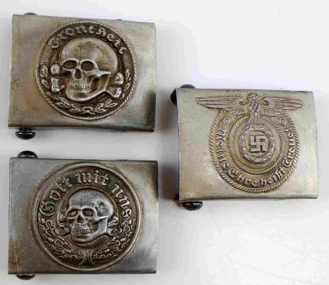 LOT OF 3 WWII GERMAN THIRD REICH SS BELT BUCKLES: Group of 3 WWII German Third Reich SS Belt buckles , Waffen SS enlisted belt buckle, and 2 variations of SS Totenkopf. Each Has an "RZM" Marking. Unauthenticated, sold as is. This lot has a reserve.